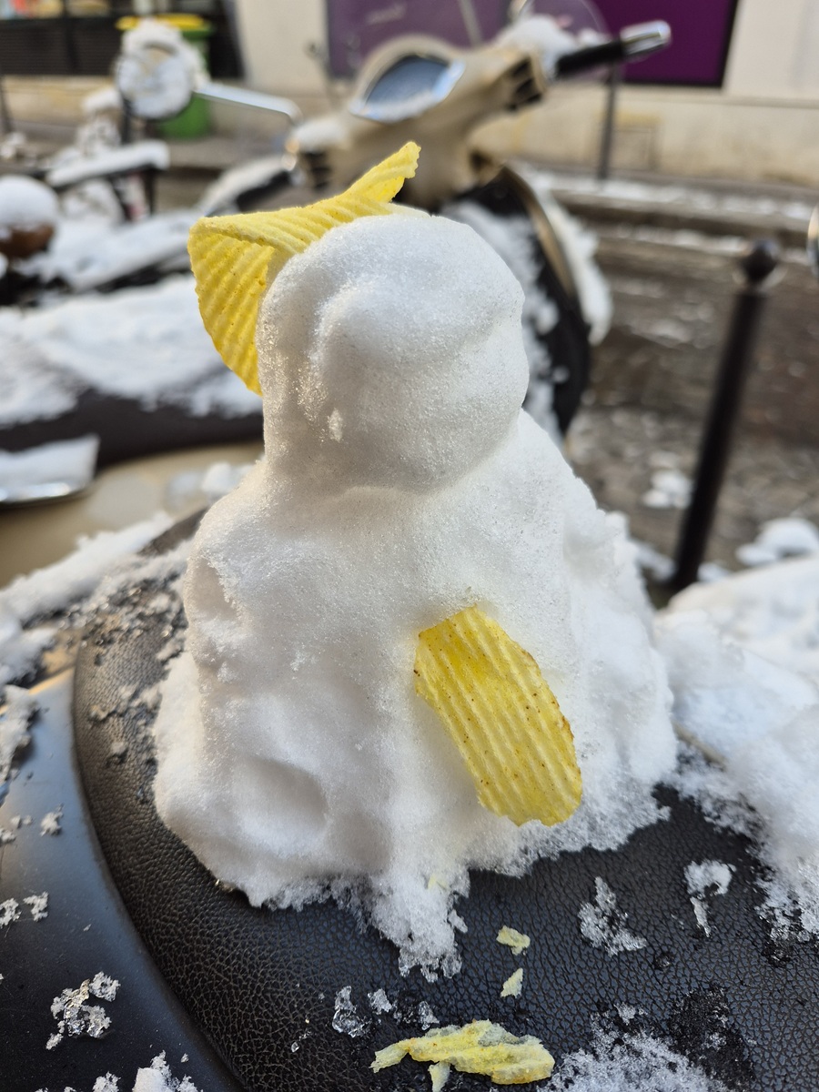 A cute little snowman that we found on the seat of a motorcycle in Montmartre on a snowy day.