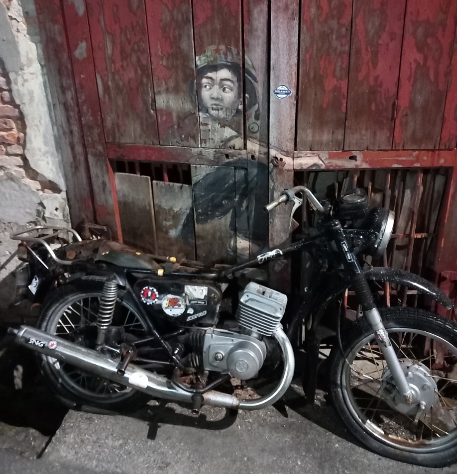 ‘Boy on Motorcycle’ street art by Ernest Zacharevic.